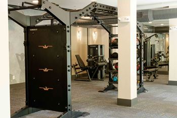 A gym with a black weight stack door.